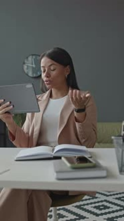 Young Businesswoman Video Conferencing on Digital Tablet in Office