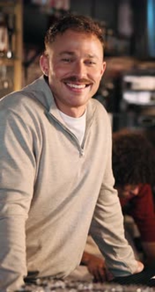 Bartender, face or man in pub with laugh, career pride or ambition as beverage server