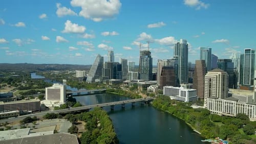 Aerial drone footage of Downtown Austin, Texas, on a cloudy day, showcasing skyscrapers, the Colorad