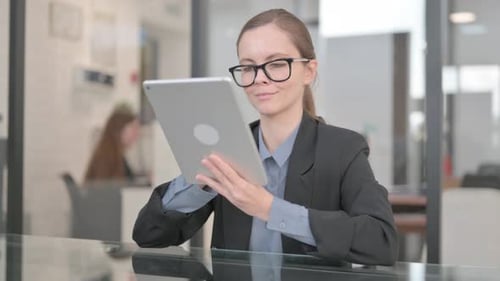 Businesswoman Working on Digital Tablet in Office