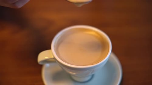 Coffee being stirred with spoon, close up