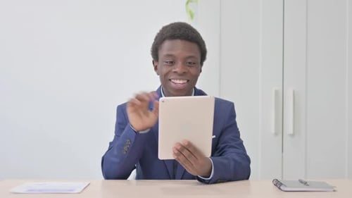 Man in Suit Video Chatting on Tablet in Office