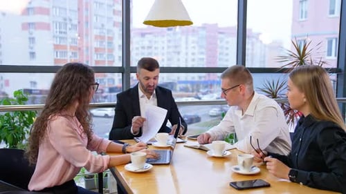 Business Professionals Work Together at Table