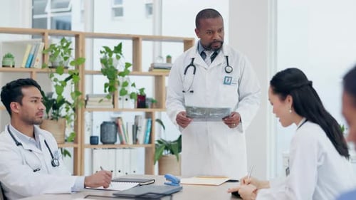 Doctors, meeting and xray for surgery planning, discussion and assessment in clinic