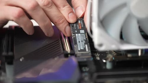 Extreme Closeup of Unrecognizable Computer Repair Technician Installing New NVMe M