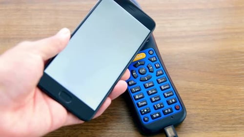 Hand Places Phone with Checkmark on Barcode Scanner