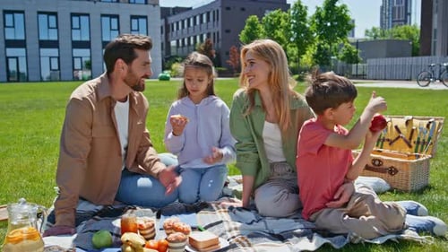 Parents Kids Enjoy Picnic on Green Grass Near Apartment Family Children Eating