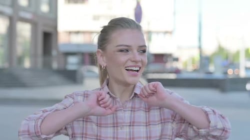 Blonde Woman Smiles Outdoors In Urban Environment