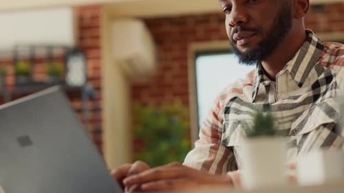 Freelancer Typing Online Information on Laptop