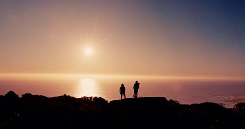 Couple, silhouette and hiking on mountain at sunset with ocean, sky and mockup space on vacation