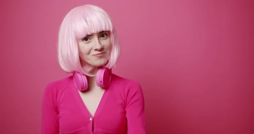 Cheerful Woman with Pink Wig Gives Thumbs Up