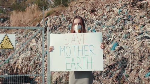 Woman Protesting at Landfill Holding Save Mother Earth Sign