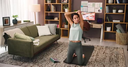 Woman Stretching on Yoga Mat in Living Room