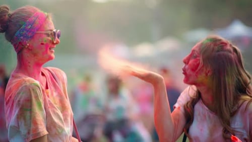 Friends Celebrating Holi Throwing Colorful Powder