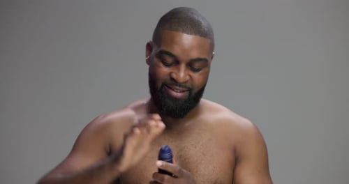 Studio, black man and armpit with deodorant for hygiene, sweat and body wellness with confident