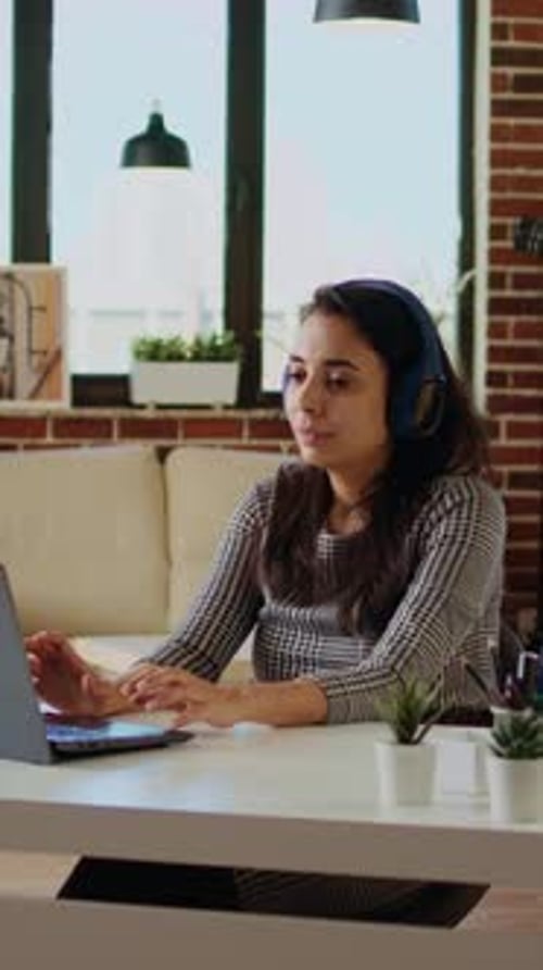 Vertical Video Woman Wearing Headphones Answering HR Interview Questions During Videoconference