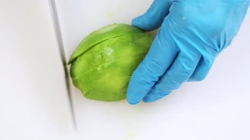 Ripe Avocado Cut Close Up on White Kitchen Board
