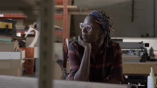 Woman with Braids Working in a Workshop