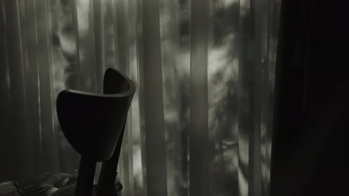 Mysterious and Intriguing Shadows That Dance Gracefully Behind a Chair in a Modern Space