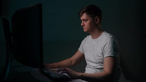 Overworked Male Programmer Looking Monitor Working Late From Home Office Focused Coder Typing
