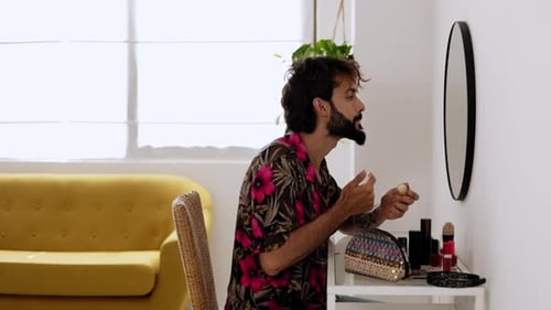 Young Adult Applying Makeup at Vanity