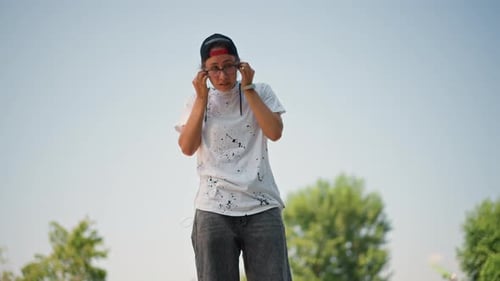 Outdoor Music Enthusiast Reflective Man Immersed in Music Beside Flowing River Asian Gentleman Lost