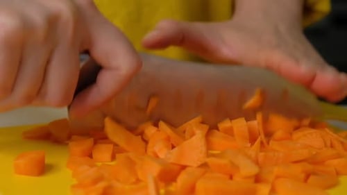 Dicing Fresh Carrots on a Cutting Board