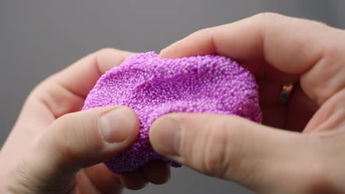 Close-Up of Pink Floam Slime Pulled by Hands for ASMR Sensation