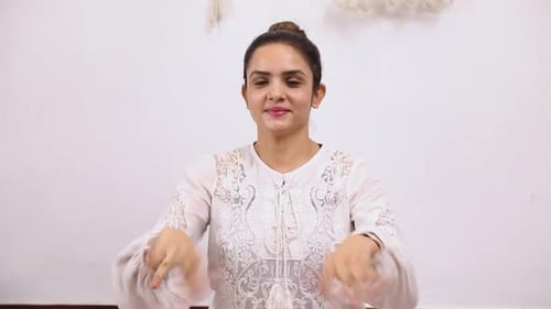 Woman Demonstrates Arm and Shoulder Movements Indoors