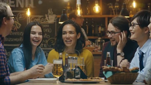 Diverse Group of Young People Have Fun in Bar, Have Conversation, Telling Stories and Jokes. They D