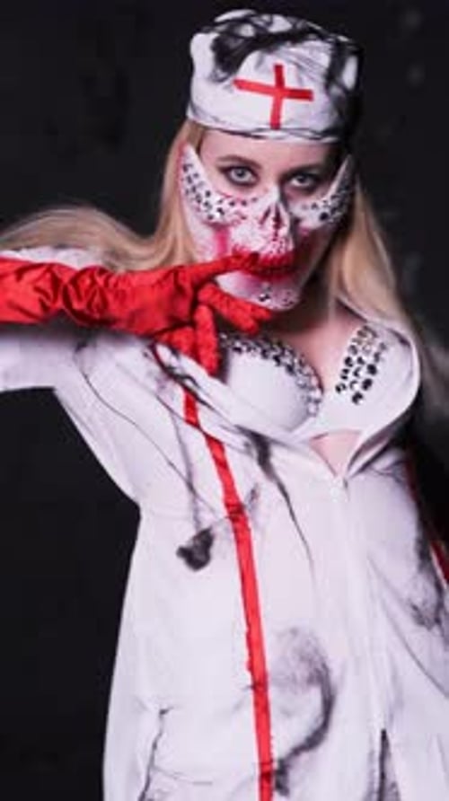 Woman in Halloween Costume Posing in the Dark