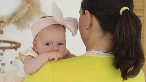 Cute Baby Being Held By A Loving Adult