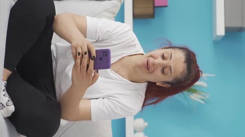 Vertical video of Happy and happy texting woman.