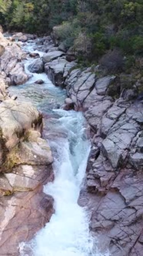 Vertical Video of Beautiful Mountain River with Cascades Flowing on Rocks