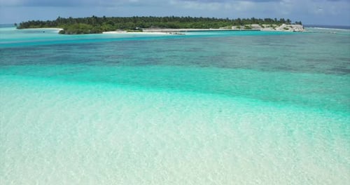 Aerial view of a scenic landscape of desert island with white sand beach and crystal clear sea wat