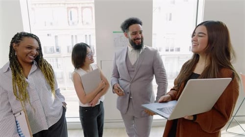 A Group of Diverse Professionals Engaged in Collaborative Activities Within a Modern Office Setting