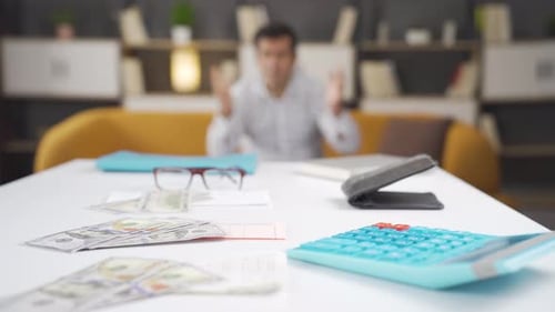 Man Stressed About Finances at Home