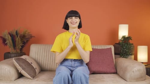 Smiling Woman Clapping and Giving Thumbs Up