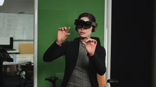 Asian female Using Virtual Reality in creative office