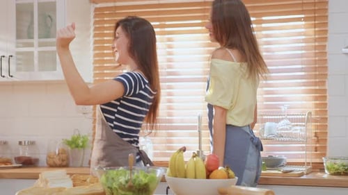 Two Young Women Dancing in Kitchen