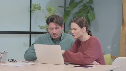 Business People Working on Laptop in Office