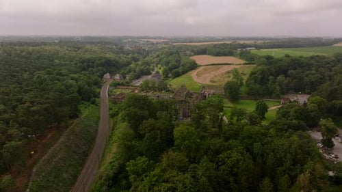 Villers Abbey Sits Nestled in a Verdant Valley Its Skeletal Stone Walls a Stark Contrast to the Lush