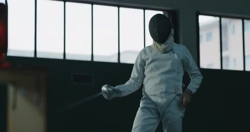 Cinematic slow motion shot of two professional young people is practising assaults of fencing with