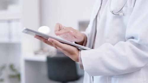Doctor Using Tablet in Hospital Close Up