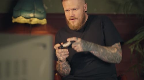 Adult Man Playing Video Games at Home