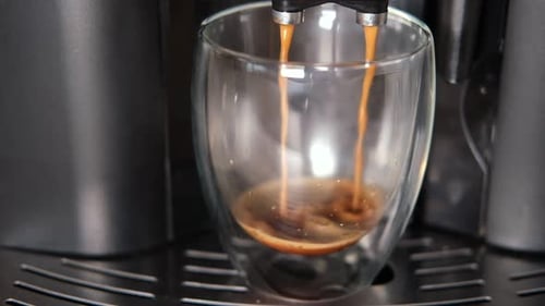 Espresso Pouring into Clear Double Walled Glass