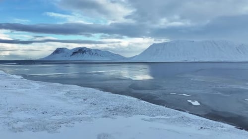 Aerial view of snow-capped mountains and frozen water, Iceland.