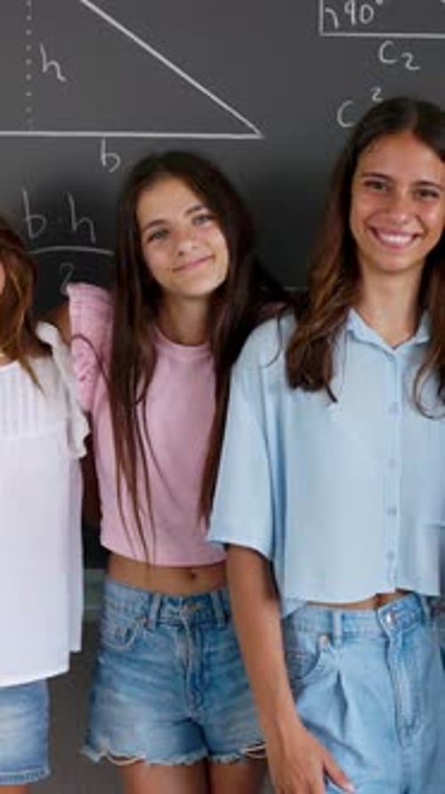 Smiling Students and Teacher In Front of Blackboard