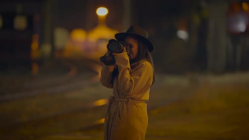Woman Taking Pictures with Camera at Night