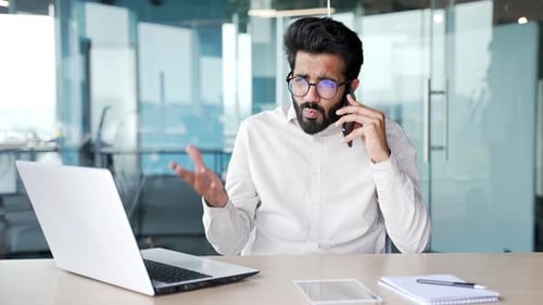 Young Adult Communicates on Mobile Phone in Office